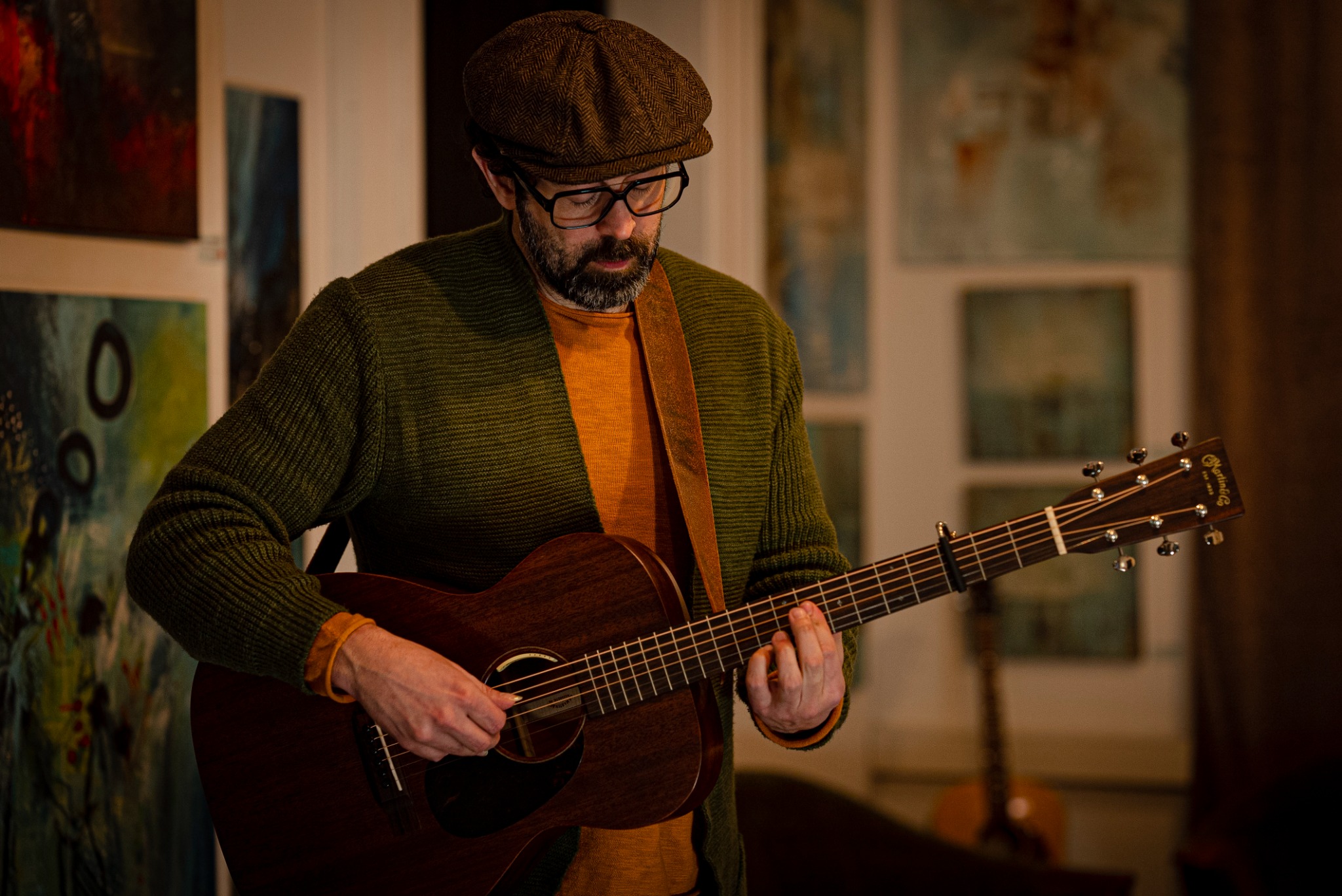 Enok Amrani playing acoustic guitar